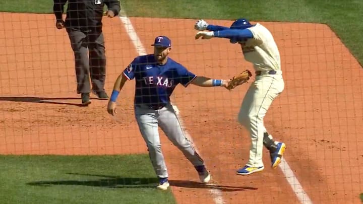 Jake Burger attempts to apply a tag to Jorge Polanco during the Seattle Mariners win over the Texas Rangers on Sunday.