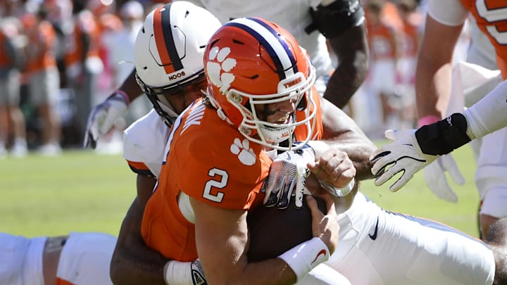 Oct 19, 2024; Clemson, South Carolina, USA; Clemson Tigers quarterback Cade Klubnik (2) attempts to elude a tackle during a game against the Virginia Cavaliers at Memorial Stadium.