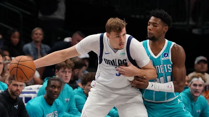 Oct 11, 2025; Dallas, Texas, USA; Dallas Mavericks forward Cooper Flagg (32) works on Charlotte Hornets forward Brandon Miller (24) in the first half of a game at American Airlines Center. Mandatory Credit: Raymond Carlin III-Imagn Images