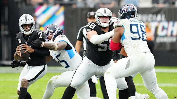 Oct 12, 2025; Paradise, Nevada, USA; Las Vegas Raiders quarterback Geno Smith (7) is sacked by Tennessee Titans linebacker Dre'Mont Jones (45) during the second half at Allegiant Stadium. Mandatory Credit: Stephen R. Sylvanie-Imagn Images