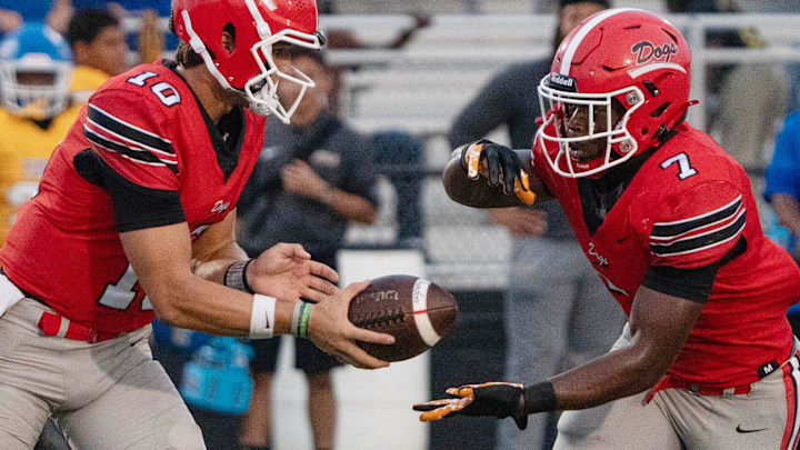 Brandon's Sladen Shack (10) hands off to Tyson Robinson (7)