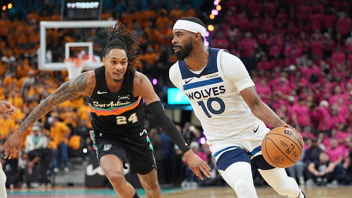 May 4, 2026; San Antonio, Texas, USA; Minnesota Timberwolves guard Mike Conley (10) dribbles against San Antonio Spurs guard Devin Vassell (24) in the first half during game one of the second round of the 2026 NBA Playoffs at Frost Bank Center. Mandatory Credit: Daniel Dunn-Imagn Images