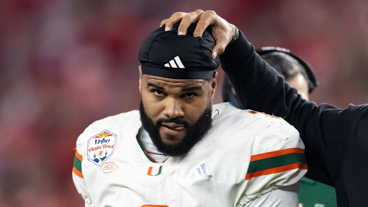 Jan 8, 2026; Glendale, AZ, USA; Miami Hurricanes defensive line coach Jason Taylor with defensive lineman Akheem Mesidor (3) against the Mississippi Rebels during the 2026 Fiesta Bowl and semifinal game of the College Football Playoff at State Farm Stadium. Mandatory Credit: Mark J. Rebilas-Imagn Images