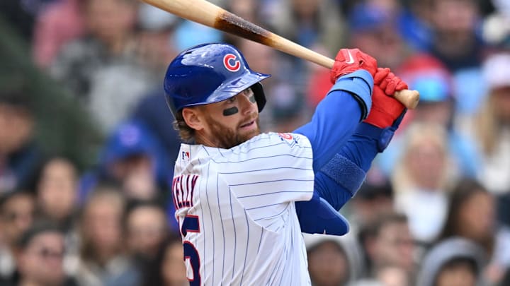 May 3, 2026; Chicago, Illinois, USA; Chicago Cubs catcher Carson Kelly (15) hits an RBI single against the Arizona Diamondbacks during the second inning at Wrigley Field. 