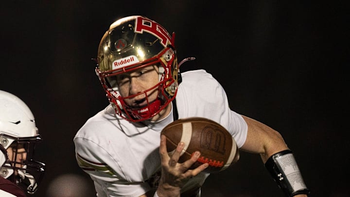 Bergen Catholic's Trey Tagliaferri (12) is sacked by Don Bosco's Jack Hinspeter (44) during Non-Public, Group A semifinal football game between Don Bosco and Bergen Catholic at Granatell Stadium in Ramsey on Friday, Nov. 21, 2025.