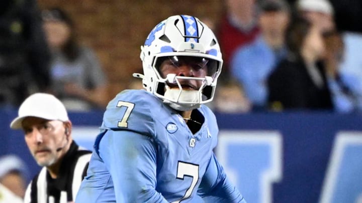 Nov 8, 2025; Chapel Hill, North Carolina, USA; North Carolina Tar Heels quarterback Gio Lopez (7) looks to pass as Stanford Cardinal safety Scotty Edwards (21) defends in the second quarter at Kenan Stadium. Mandatory Credit: Bob Donnan-Imagn Images