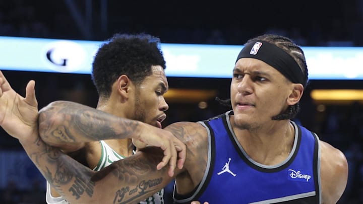 Orlando Magic forward Paolo Banchero is guarded by Boston Celtics guard Anfernee Simons.