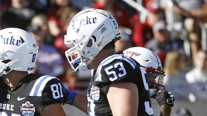 Dec 23, 2023; Birmingham, AL, USA; Duke Blue Devils tight end Cole Finney (82) and offensive linemen Brian Parker II (53) react with tight end Nicky Dalmolin (81) after a successful two-point conversion during the first half against the Troy Trojans at Protective Stadium. Mandatory Credit: Petre Thomas-Imagn Images