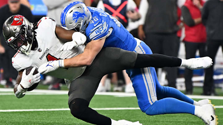 Jan 21, 2024; Detroit, Michigan, USA; Detroit Lions linebacker Jack Campbell (46) tackles Tampa Bay Buccaneers running back Rachaad White (1) during the first quarter in a 2024 NFC divisional round game at Ford Field. Mandatory Credit: Lon Horwedel-Imagn Images Jan 21, 2024; Detroit, Michigan, USA; Detroit Lions linebacker Jack Campbell (46) tackles Tampa Bay Buccaneers running back Rachaad White (1) during the first quarter in a 2024 NFC divisional round game at Ford Field. Mandatory Credit: Lon Horwedel-Imagn Images