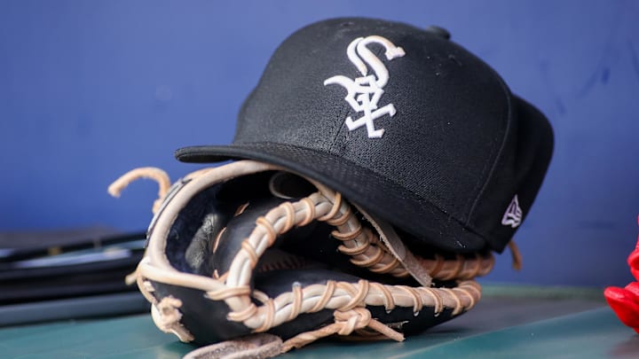 Jul 15, 2023; Atlanta, Georgia, USA; A detailed view of a Chicago White Sox hat and glove in the dugout against the Atlanta Braves in the first inning at Truist Park. 