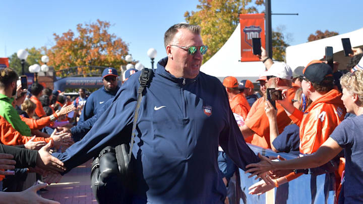 Oct 19, 2024; Champaign, Illinois, USA; Illinois Fighting Illini head coach Bret Bielema leads his team into the stadium before kickoff against the Michigan Wolverines game at Memorial Stadium. Mandatory Credit: Ron Johnson-Imagn Images