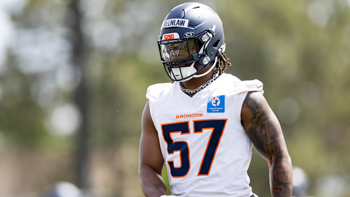 Denver Broncos linebacker Dre Greenlaw (57) works out during mandatory minicamp. 