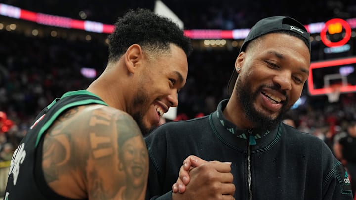 Dec 28, 2025; Portland, Oregon, USA; Boston Celtics guard Anfernee Simons (4) and Portland Trail Blazers guard Damian Lillard (0) meet after the game at Moda Center. Mandatory Credit: Soobum Im-Imagn Images