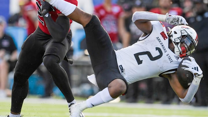 Northern Illinois Huskies safety Muhammed Jammeh (21) stops Arkansas State Red Wolves running back Ja'Quez Cross (2) in second half action in the Camellia Bowl at Cramton Bowl in Montgomery, Ala., on Saturday December 23, 2023.
