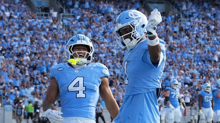 Sep 13, 2025; Chapel Hill, North Carolina, USA; North Carolina Tar Heels wide receiver Jordan Shipp (1) celebrates with wide receiver Alex Taylor (0) and running back Caleb Hood (4) after making a touchdown catch in the third quarter at Kenan Stadium. Mandatory Credit: Bob Donnan-Imagn Images