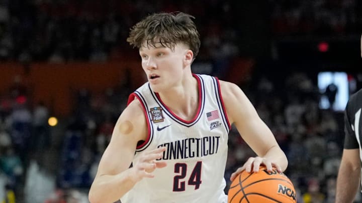 UConn Huskies guard Braylon Mullins (24) looks for a pass Saturday, April 4, 2026, during a Final Four game against the Illinois Fighting Illini at Lucas Oil Stadium in Indianapolis.