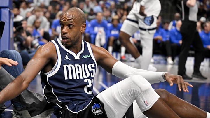 Feb 27, 2026; Dallas, Texas, USA; Dallas Mavericks forward Khris Middleton (20) checks on a tv cameraman after Middleton collides with him on the floor during the second half against the Memphis Grizzlies at the American Airlines Center. Mandatory Credit: Jerome Miron-Imagn Images