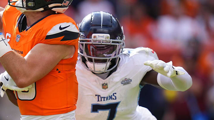 Tennessee Titans linebacker Femi Oladejo tries to tackle Denver Broncos quarterback Bo Nix.