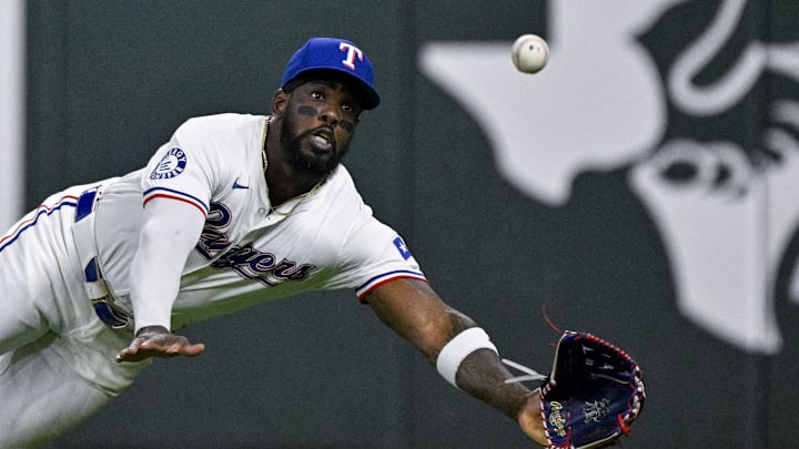 Sep 5, 2024; Arlington, Texas, USA; Texas Rangers right fielder Adolis Garcia (53) leaps but cannot catch a fly ball hit by Los Angeles Angels designated hitter Brandon Drury (not pictured) during the seventh inning at Globe Life Field. Mandatory Credit: Jerome Miron-Imagn Images Sep 5, 2024; Arlington, Texas, USA; Texas Rangers right fielder Adolis Garcia (53) leaps but cannot catch a fly ball hit by Los Angeles Angels designated hitter Brandon Drury (not pictured) during the seventh inning at Globe Life Field. Mandatory Credit: Jerome Miron-Imagn Images