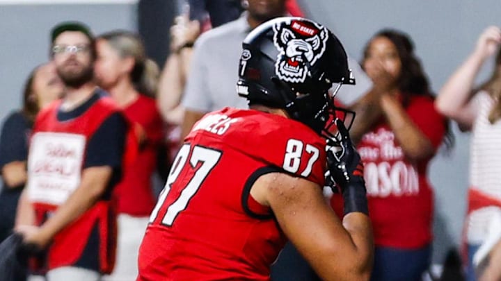 Sep 27, 2025; Raleigh, North Carolina, USA;  North Carolina State Wolfpack tight end Dante Daniels (87) makes a touchdown during the first half of the game against Virginia Tech Hokies at Carter-Finley Stadium. Mandatory Credit: Jaylynn Nash-Imagn Images