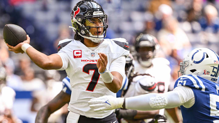 Sep 8, 2024; Indianapolis, Indiana, USA; Houston Texans quarterback C.J. Stroud (7) throws a ball over Indianapolis Colts defensive end Kwity Paye (51) during the second half at Lucas Oil Stadium. Mandatory Credit: Marc Lebryk-Imagn Images