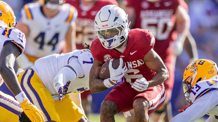 Arkansas Razorbacks wide receiver Raylen Sharpe (6) runs against LSU Tigers defensive back A.J. Haulcy (13) and linebacker Harold Perkins Jr. (7) during the second half at Tiger Stadium.