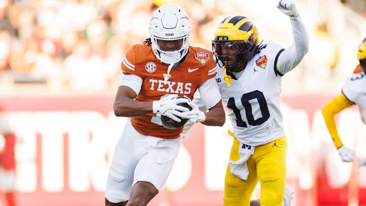 Texas Longhorns wide receiver Ryan Wingo runs with the ball while Michigan Wolverines defensive back Zeke Berry.