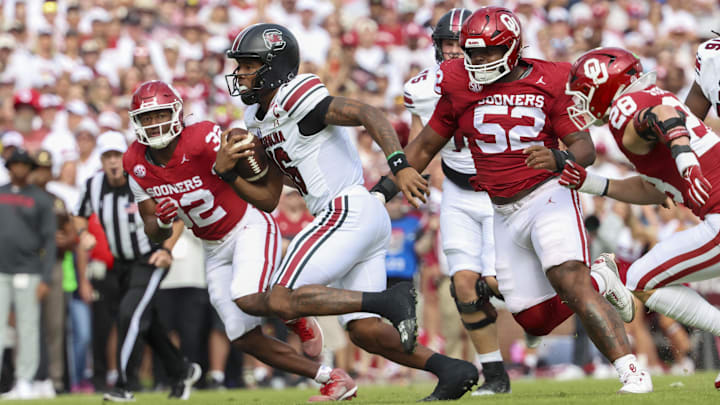 South Carolina quarterback LaNorris Sellers is chased by Oklahoma's defense.