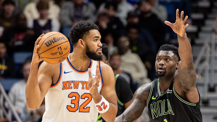 Dec 29, 2025; New Orleans, Louisiana, USA;  New York Knicks center/forward Karl-Anthony Towns (32) dribbles against New Orleans Pelicans forward Zion Williamson (1) during the second half at Smoothie King Center. Mandatory Credit: Stephen Lew-Imagn Images