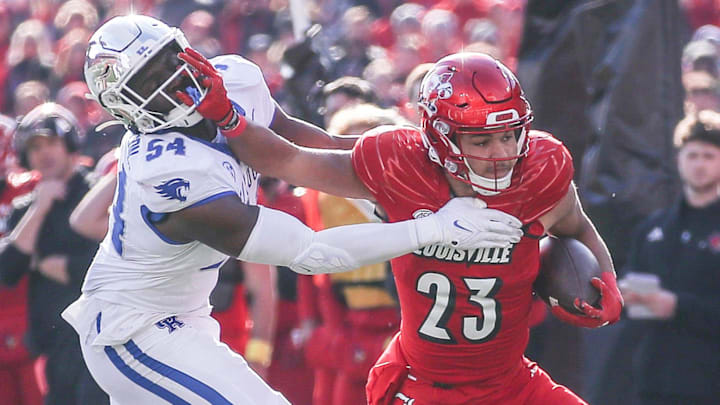 Kentucky Wildcats linebacker D'Eryk Jackson (54) tries to stop Louisville Cardinals running back