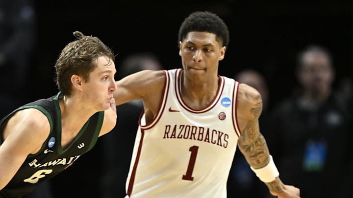 Hawaii Rainbow Warriors forward Isaac Finlinson (6) drives against Arkansas Razorbacks guard Meleek Thomas (1) in the second half during a first round game of the men's 2026 NCAA Tournament at Moda Center.