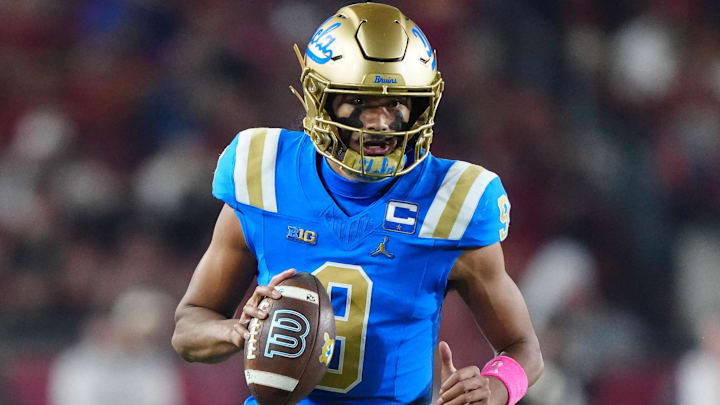 Nov 29, 2025; Los Angeles, California, USA; UCLA Bruins quarterback Nico Iamaleava (9) carries the ball against the Southern California Trojans in the first half at United Airlines Field at Los Angeles Memorial Coliseum. Mandatory Credit: Kirby Lee-Imagn Images