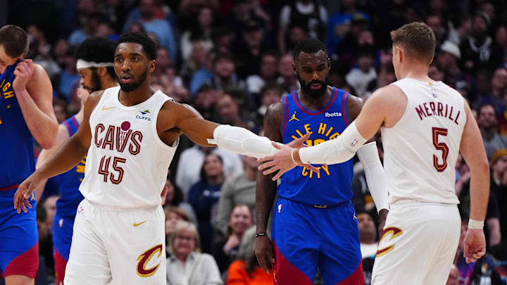 Feb 9, 2026; Denver, Colorado, USA; Cleveland Cavaliers guard Donovan Mitchell (45) reacts with guard Sam Merrill (5) following his free throw shots in the fourth quarter against the Denver Nuggets at Ball Arena. Mandatory Credit: Ron Chenoy-Imagn Images