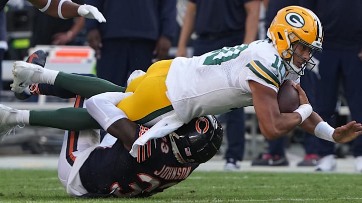 Green Bay Packers quarterback Jordan Love (10) is tackled short of a first down by Chicago Bears cornerback Jaylon Johnson (33) during the third quarter of their regular season opening game Sunday, September 10, 2023 at Soldier Field in Chicago, Ill. The Green Bay Packers beat the Chicago Bears 38-20.