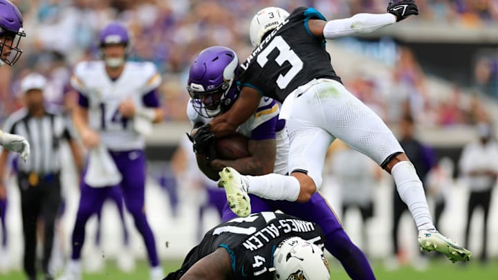Jacksonville Jaguars cornerback Tyson Campbell (3) and defensive end Josh Hines-Allen (41) stop Minnesota Vikings running back Cam Akers (27) during the third quarter of an NFL football matchup Sunday, Nov. 10, 2024 at Everbank Stadium in Jacksonville, Fla. The Vikings defeated the Jaguars 12-7. [Corey Perrine/Florida Times-Union]