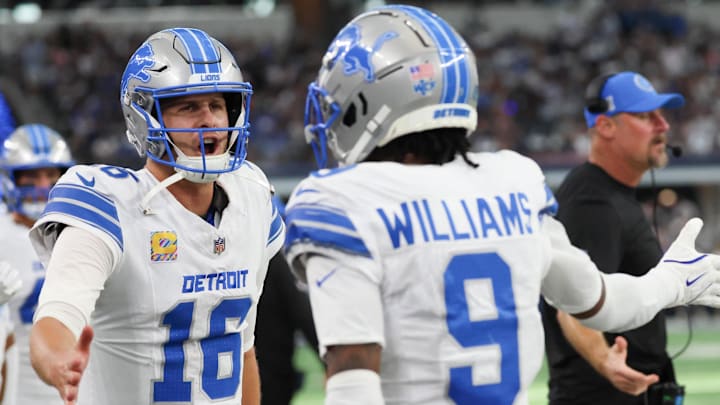 Detroit Lions wide receiver Jameson Williams (9) celebrates with Detroit Lions quarterback Jared Goff (16) 
