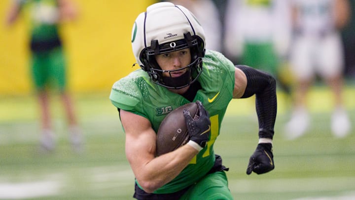 Oregon defensive back Dillon Thieneman carries the ball as the Oregon Ducks practice on Jan. 5, 2025, at the Moshofsky Center in Eugene, Oregon, ahead of the Peach Bowl.