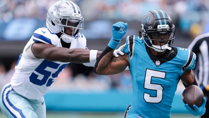 Oct 12, 2025; Charlotte, North Carolina, USA; Carolina Panthers running back Rico Dowdle (5) runs past Dallas Cowboys linebacker Kenneth Murray, Jr. (59) in the first quarter at Bank of America Stadium. Oct 12, 2025; Charlotte, North Carolina, USA; Carolina Panthers running back Rico Dowdle (5) runs past Dallas Cowboys linebacker Kenneth Murray, Jr. (59) in the first quarter at Bank of America Stadium.