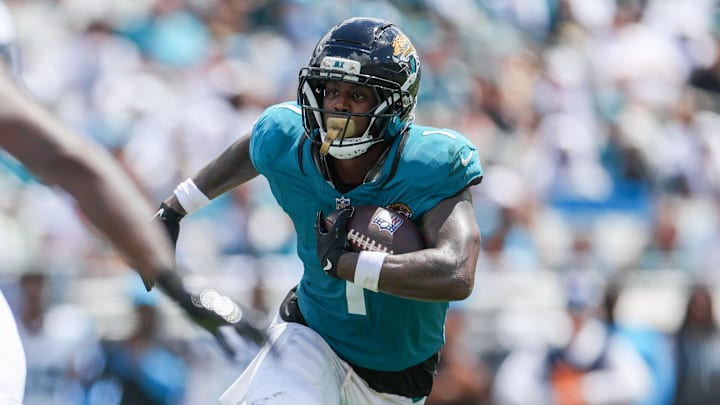 Sep 7, 2025; Jacksonville, Florida, USA; Jacksonville Jaguars running back Travis Etienne Jr. (1) carries the ball against the Carolina Panthers during the first half at EverBank Stadium. Mandatory Credit: Nathan Ray Seebeck-Imagn Images