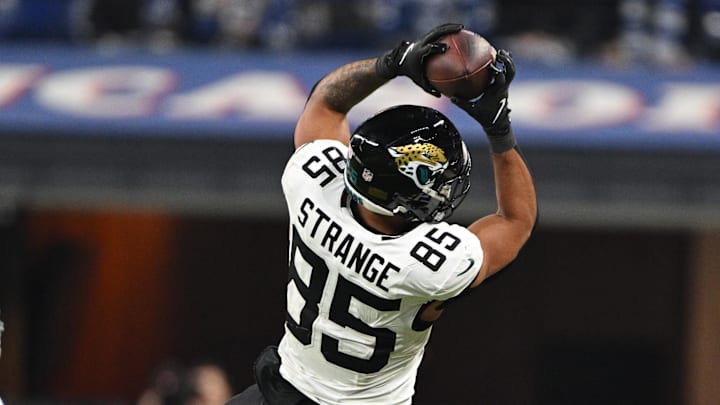 Jan 5, 2025; Indianapolis, Indiana, USA; Jacksonville Jaguars tight end Brenton Strange (85) jumps to catch a ball in front of Indianapolis Colts cornerback Kenny Moore II (23) during the second half at Lucas Oil Stadium. Mandatory Credit: Marc Lebryk-Imagn Images