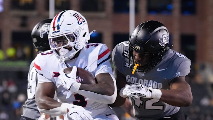 Nov 1, 2025; Boulder, Colorado, USA; Arizona Wildcats running back Kedrick Reescano (3) scores a touchdown past Colorado Buffaloes linebacker Jeremiah Brown (42) in the second half at Folsom Field. Mandatory Credit: Ron Chenoy-Imagn Images