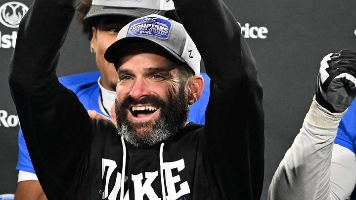 Dec 6, 2025; Charlotte, NC, USA; Duke Blue Devils head coach Manny Diaz lifts the ACC trophy with offensive lineman Justin Pickett (77) and defensive tackle Aaron Hall (99) after defeating the Virginia Cavaliers at the 2025 ACC Championship game at Bank of America Stadium. Mandatory Credit: Bob Donnan-Imagn Images Dec 6, 2025; Charlotte, NC, USA; Duke Blue Devils head coach Manny Diaz lifts the ACC trophy with offensive lineman Justin Pickett (77) and defensive tackle Aaron Hall (99) after defeating the Virginia Cavaliers at the 2025 ACC Championship game at Bank of America Stadium. Mandatory Credit: Bob Donnan-Imagn Images