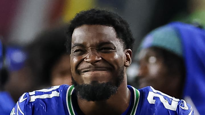 Seattle Seahawks cornerback Devon Witherspoon grimaces