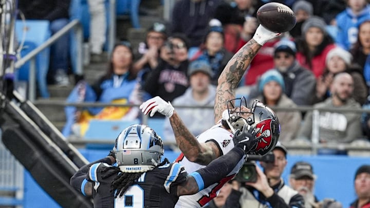 Dec 1, 2024; Charlotte, North Carolina, USA; Tampa Bay Buccaneers wide receiver Mike Evans (13) reaches for the touchdown catch defended by Carolina Panthers cornerback Jaycee Horn (8) during the first quarter at Bank of America Stadium. Mandatory Credit: Jim Dedmon-Imagn Images