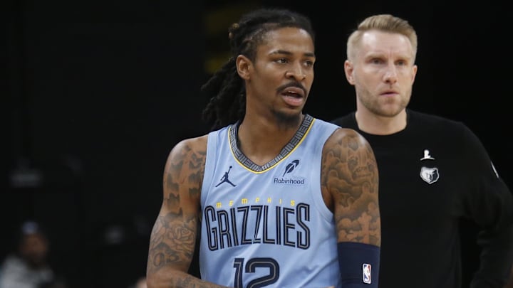 Jan 21, 2026; Memphis, Tennessee, USA; Memphis Grizzlies guard Ja Morant (12) and head coach Tuomas Iisalo looks on during the third quarter against the Atlanta Hawks at FedExForum.