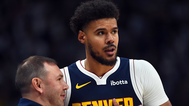 Oct 25, 2025; Denver, Colorado, USA; Denver Nuggets forward Cameron Johnson (23) talks with head coach David Adelman during the first half against the Phoenix Suns at Ball Arena.