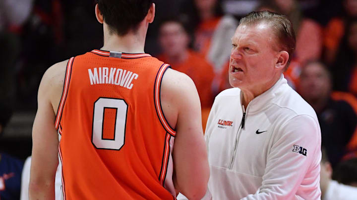 Illinois Fighting Illini head coach Brad Underwood talks to forward David Mirkovic (0) against the Northwestern Wildcats at State Farm Center. 