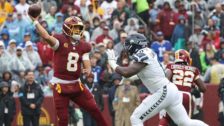 Sep 27, 2026; Landover, Maryland, USA; Washington Commanders quarterback Marcus Mariota (8) passes the ball under pressure from Seattle Seahawks linebacker DeMarcus Lawrence (0) at Northwest Stadium. Mandatory Credit: Geoff Burke-Imagn Images
