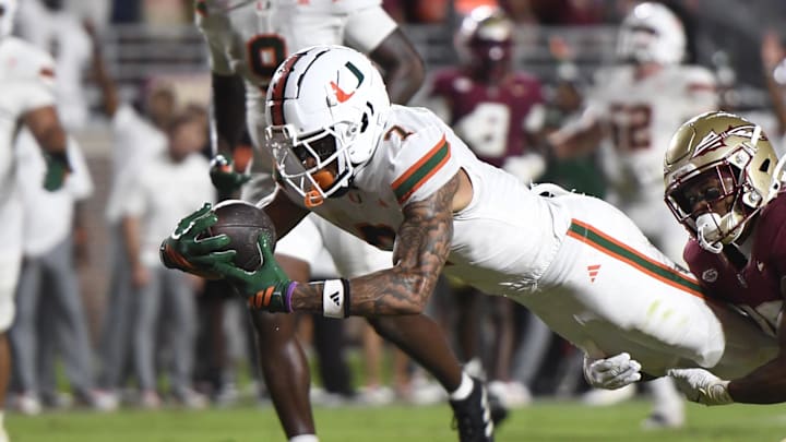 Oct 4, 2025; Tallahassee, Florida, USA; Miami Hurricanes wide receiver CJ Daniels (7) scores a touchdown against Florida State Seminoles defensive back Jerry Wilson (19) during the second half at Doak S. Campbell Stadium. Mandatory Credit: Robert Myers-Imagn Images