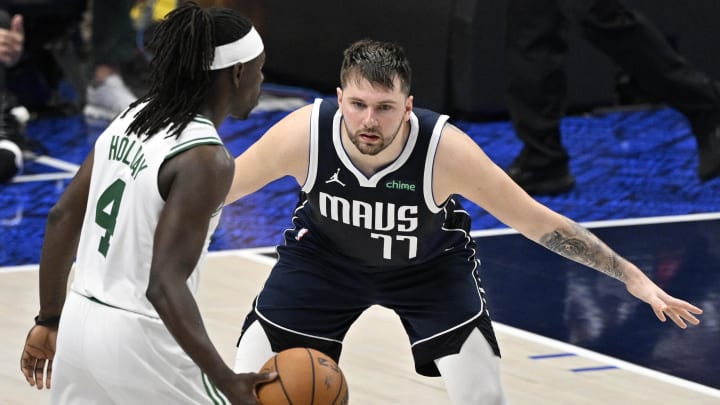 Jun 12, 2024; Dallas, Texas, USA; Dallas Mavericks guard Luka Doncic (77) guards Boston Celtics guard Jrue Holiday (4) during the fourth quarter in game three of the 2024 NBA Finals at American Airlines Center. Mandatory Credit: Jerome Miron-USA TODAY Sports Jun 12, 2024; Dallas, Texas, USA; Dallas Mavericks guard Luka Doncic (77) guards Boston Celtics guard Jrue Holiday (4) during the fourth quarter in game three of the 2024 NBA Finals at American Airlines Center. Mandatory Credit: Jerome Miron-USA TODAY Sports